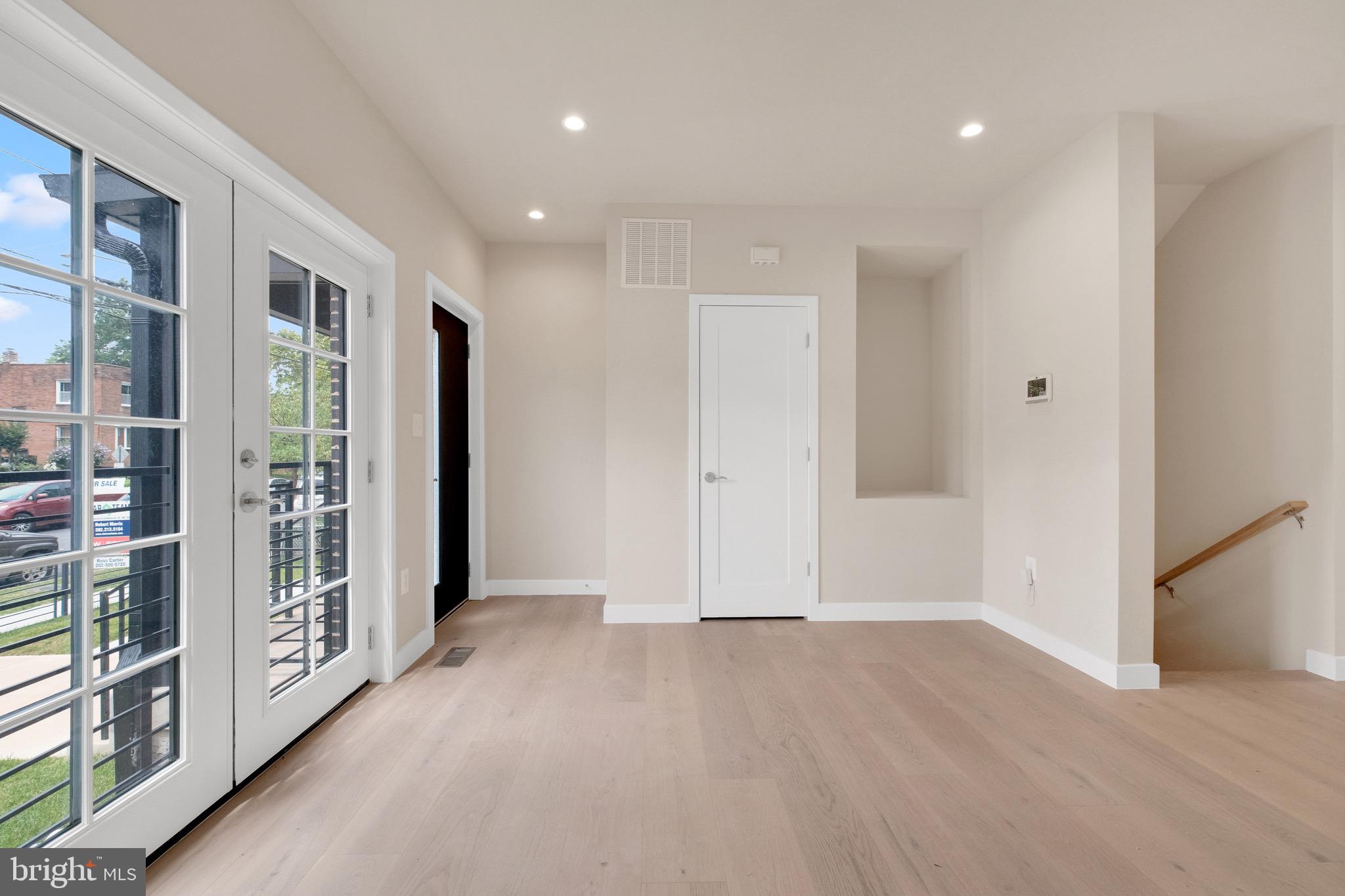 854 Xenia Street Southeast, Unit 102 Washington, DC 20032 - Photo 4 of 28 a view of an empty room with wooden floor and a window