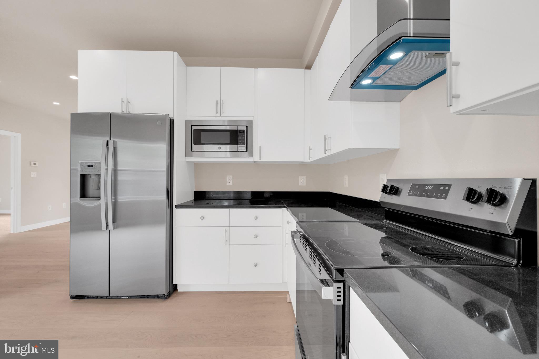 854 Xenia Street Southeast, Unit 102 Washington, DC 20032 - Photo 8 of 28 a kitchen with a refrigerator and a sink