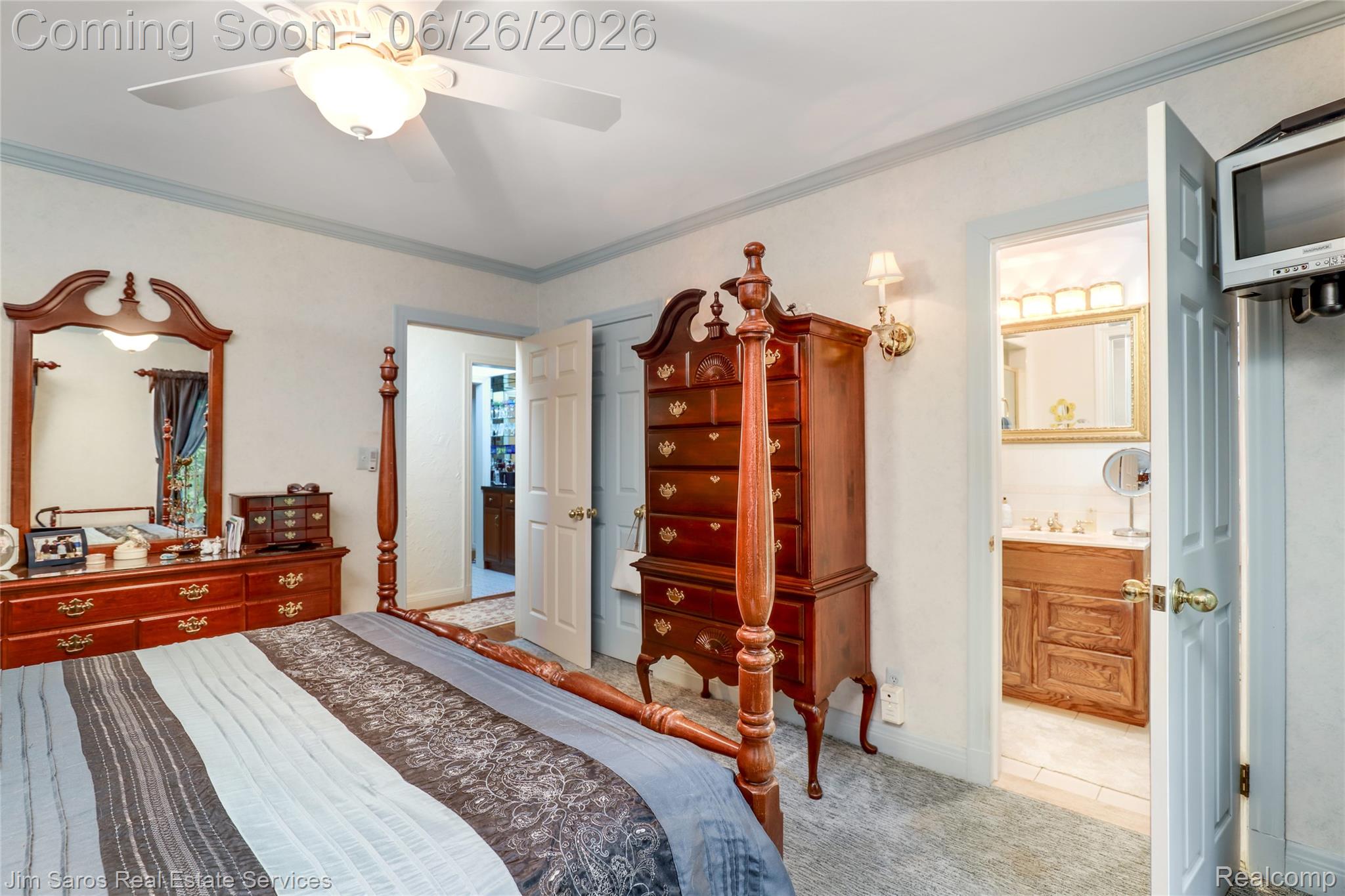 764 Harcourt Road Grosse Pointe, MI 48230 - Photo 15 of 42 Carpeted room featuring a ceiling fan with integrated lighting, light-colored walls with blue trim, a recessed doorway, a bifold door, and a wall-mounted sconce