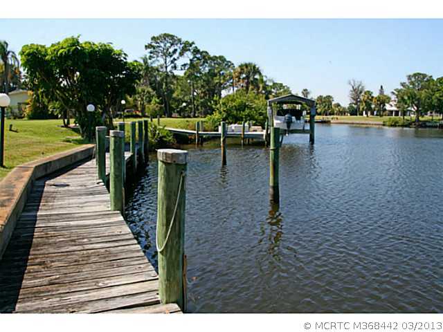 884 Northwest Spruce Ridge Drive Stuart, FL 34994 - Photo 4 of 25 Waterfront/Dock/Pier. Canal view from the seawall and dock.