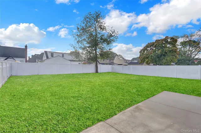 a view of a yard with a house in the background