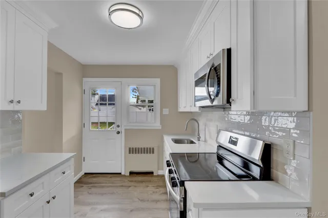 a kitchen with granite countertop a stove and a sink