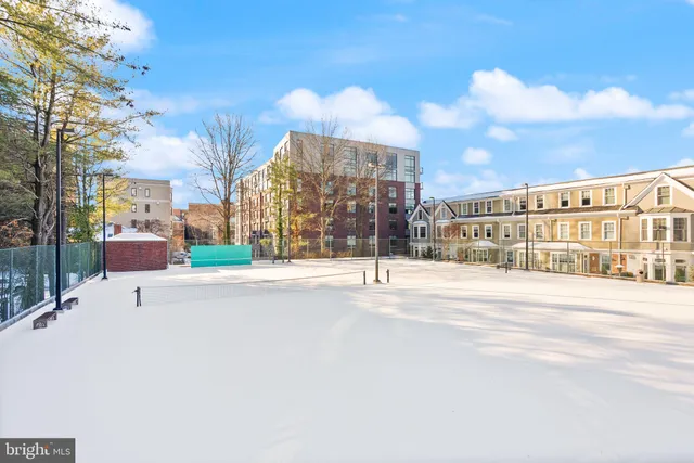 a view of a brick building next to a yard