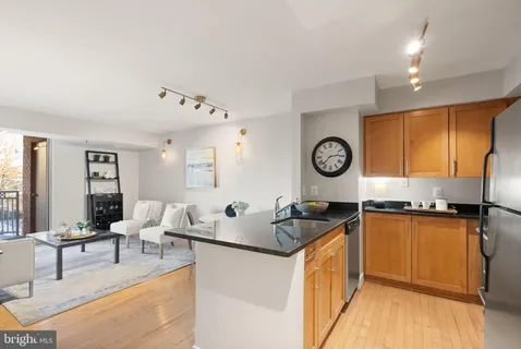 a kitchen with stainless steel appliances granite countertop a sink and cabinets