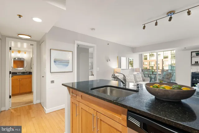 a kitchen with sink a faucet and chairs