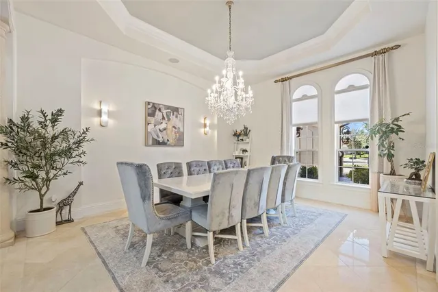 a view of a dining room with furniture and chandelier