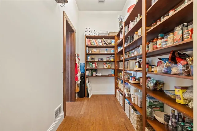 a spacious bedroom with a bed a couch and a window
