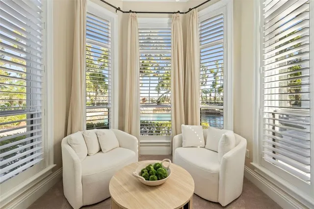 a spacious bedroom with a bed and a chandelier