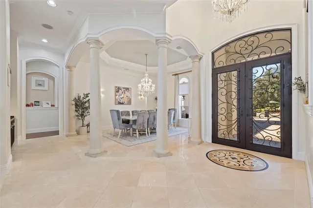 a living room with fireplace furniture and a potted plant