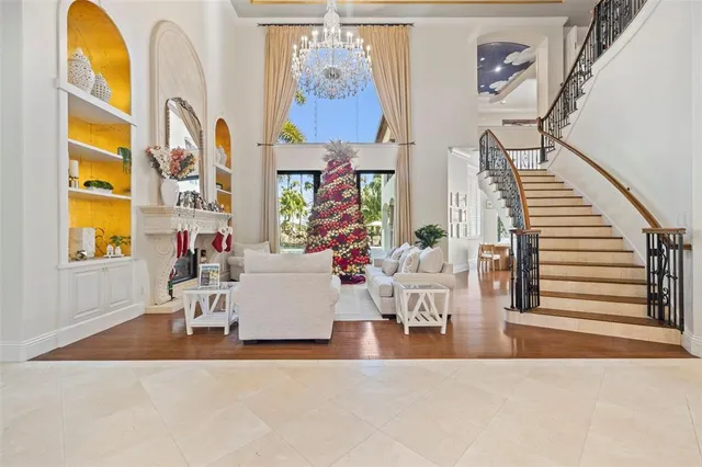 a living room with fireplace furniture and a potted plant