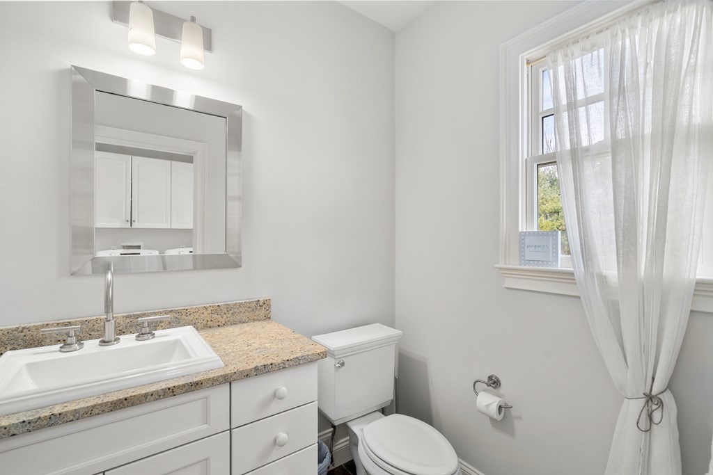 130 Summer Street Weston, MA 02493 - Photo 21 of 26 a bathroom with a granite countertop sink toilet and mirror