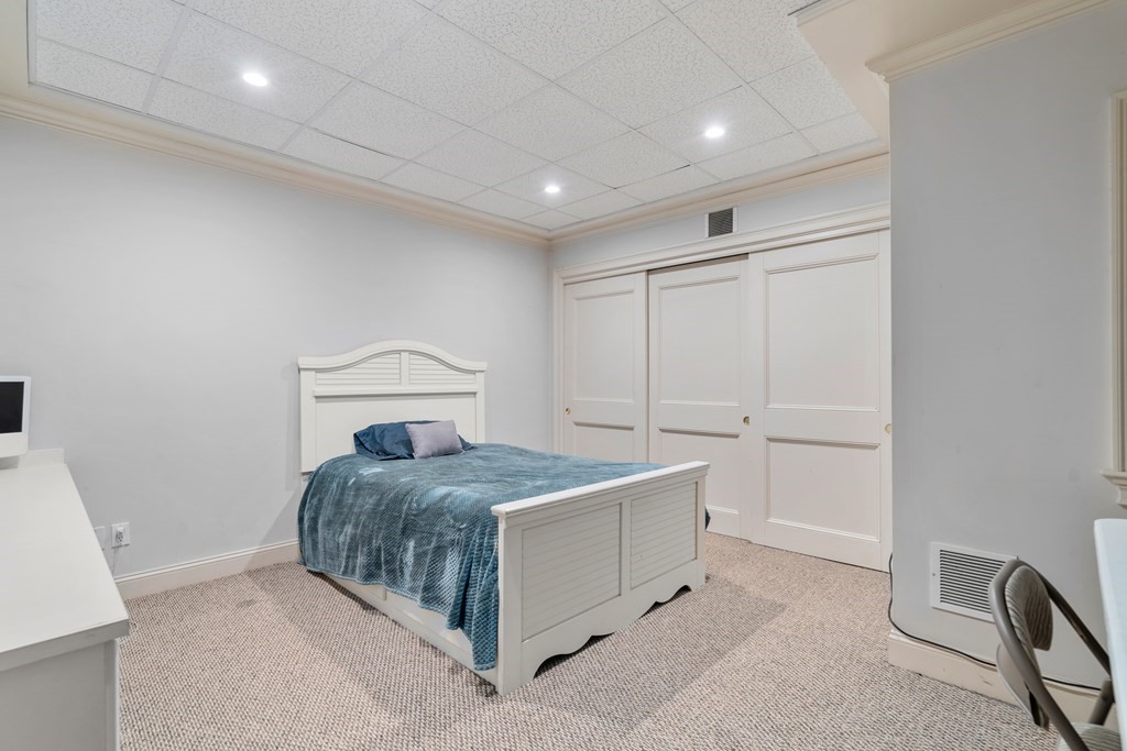 130 Summer Street Weston, MA 02493 - Photo 22 of 26 a bedroom with a bed and a table in it