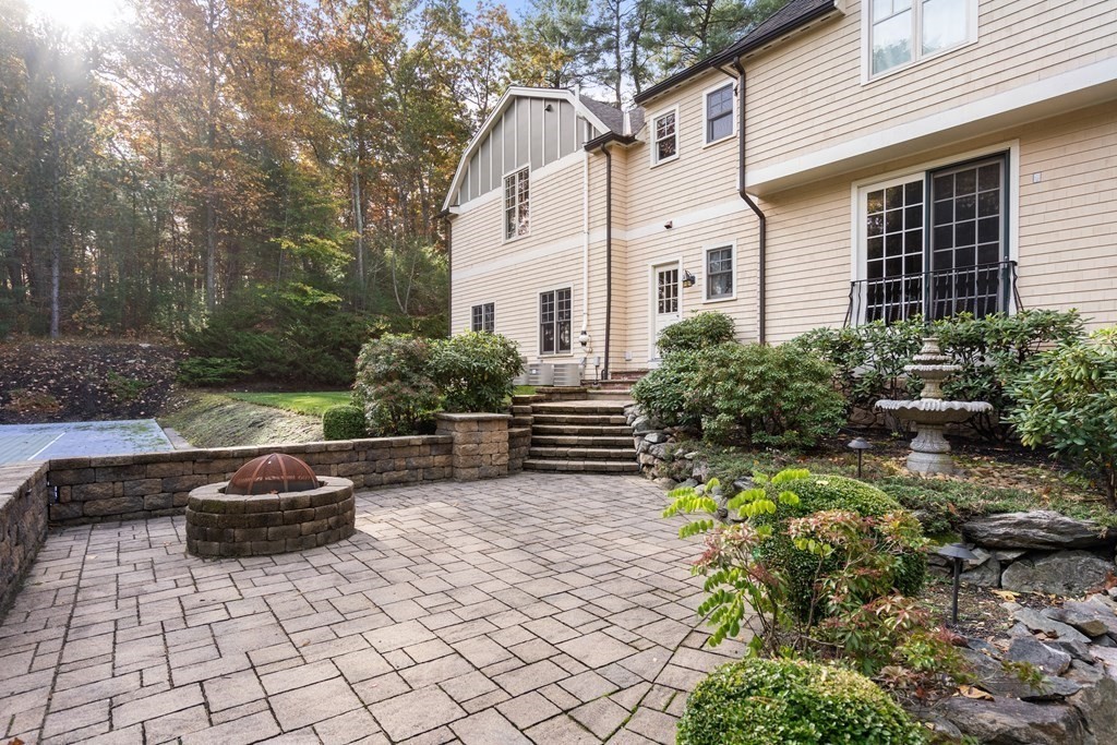 130 Summer Street Weston, MA 02493 - Photo 7 of 26 a front view of a house with a garden