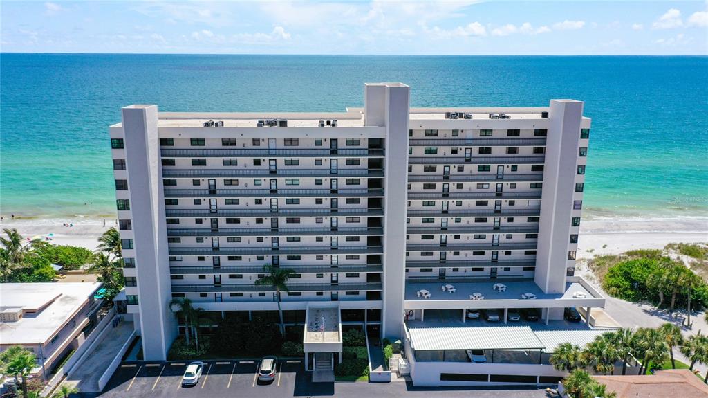 15462 Gulf Boulevard, Unit 501 Madeira Beach, FL 33708 - Photo 1 of 88 a front view of a building with glass windows