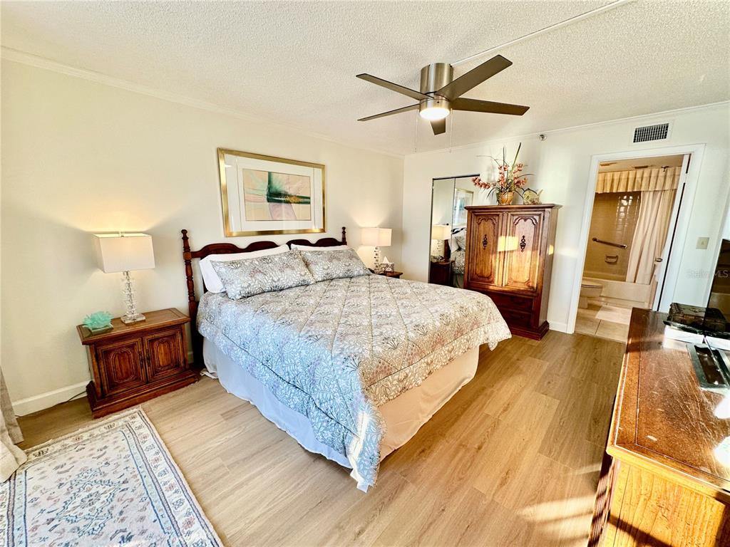 15462 Gulf Boulevard, Unit 501 Madeira Beach, FL 33708 - Photo 13 of 88 a bedroom with a bed and wooden floor