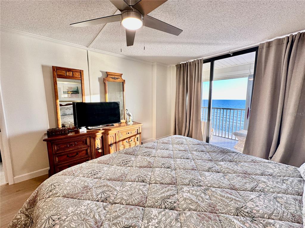 15462 Gulf Boulevard, Unit 501 Madeira Beach, FL 33708 - Photo 17 of 88 a bedroom with a bed and a flat screen tv
