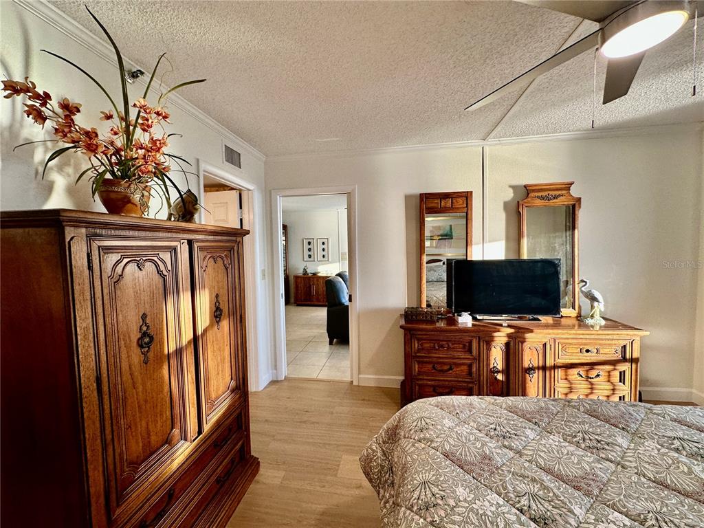 15462 Gulf Boulevard, Unit 501 Madeira Beach, FL 33708 - Photo 18 of 88 a bedroom with a bed and a flat screen tv