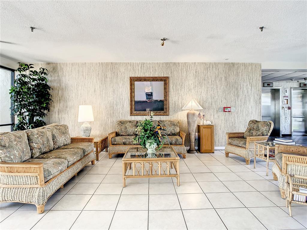 15462 Gulf Boulevard, Unit 501 Madeira Beach, FL 33708 - Photo 27 of 88 a living room with furniture and a potted plant
