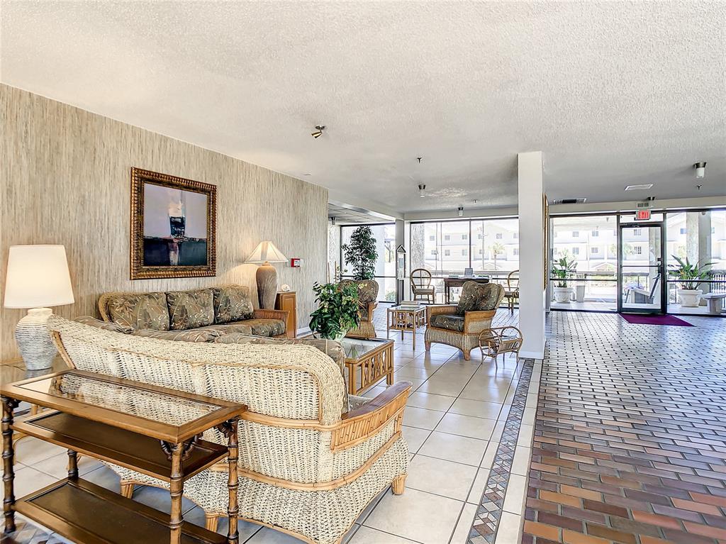 15462 Gulf Boulevard, Unit 501 Madeira Beach, FL 33708 - Photo 28 of 88 a living room with a large window and furniture