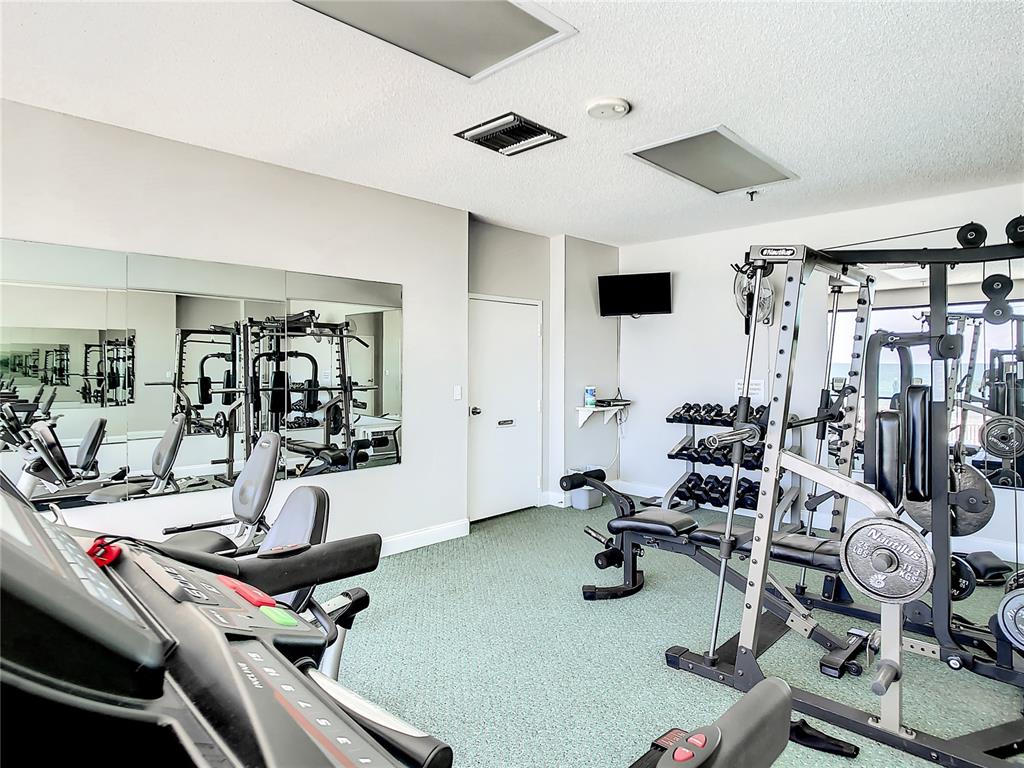 15462 Gulf Boulevard, Unit 501 Madeira Beach, FL 33708 - Photo 36 of 88 a room with gym equipment and a large window