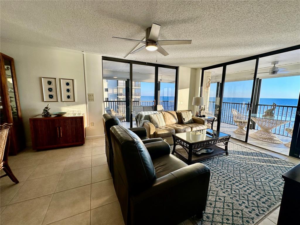 15462 Gulf Boulevard, Unit 501 Madeira Beach, FL 33708 - Photo 4 of 88 a living room with furniture and a floor to ceiling window