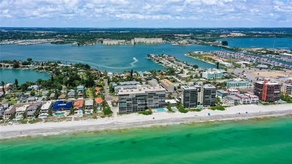 a view of a dining room with furniture a chandelier and wooden floor