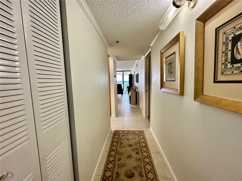 15462 Gulf Boulevard, Unit 501 Madeira Beach, FL 33708 - Photo 48 of 88 a view of a hallway with wooden floor and furniture