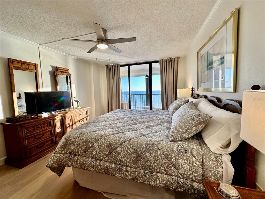 15462 Gulf Boulevard, Unit 501 Madeira Beach, FL 33708 - Photo 6 of 88 a bedroom with a bed and a flat screen tv
