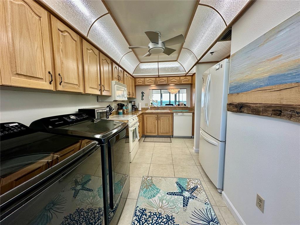 15462 Gulf Boulevard, Unit 501 Madeira Beach, FL 33708 - Photo 61 of 88 a kitchen with stainless steel appliances granite countertop a stove and a refrigerator