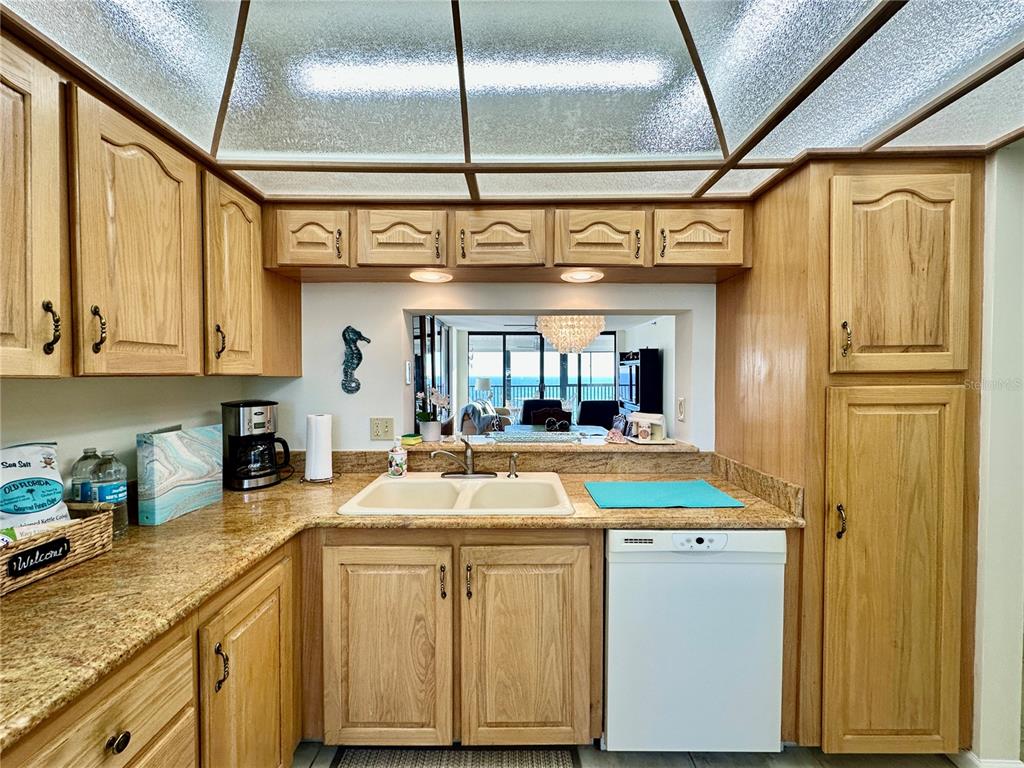 15462 Gulf Boulevard, Unit 501 Madeira Beach, FL 33708 - Photo 66 of 88 a kitchen with stainless steel appliances granite countertop a sink and cabinets