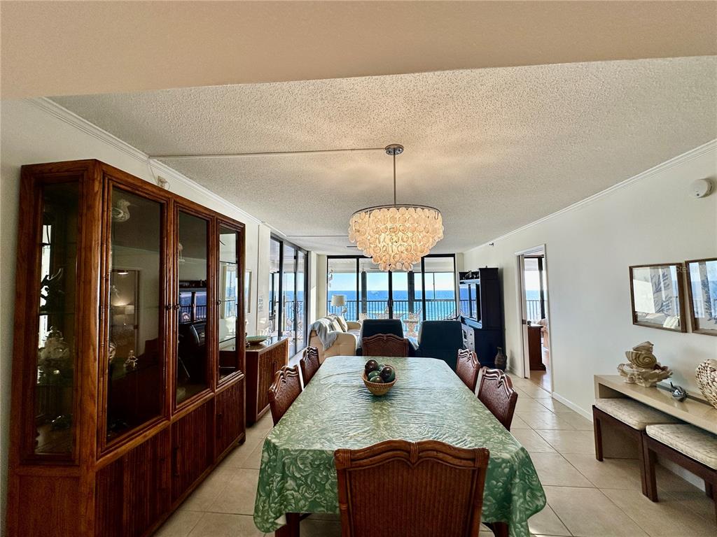 15462 Gulf Boulevard, Unit 501 Madeira Beach, FL 33708 - Photo 67 of 88 a view of a dining room with furniture a chandelier and kitchen view