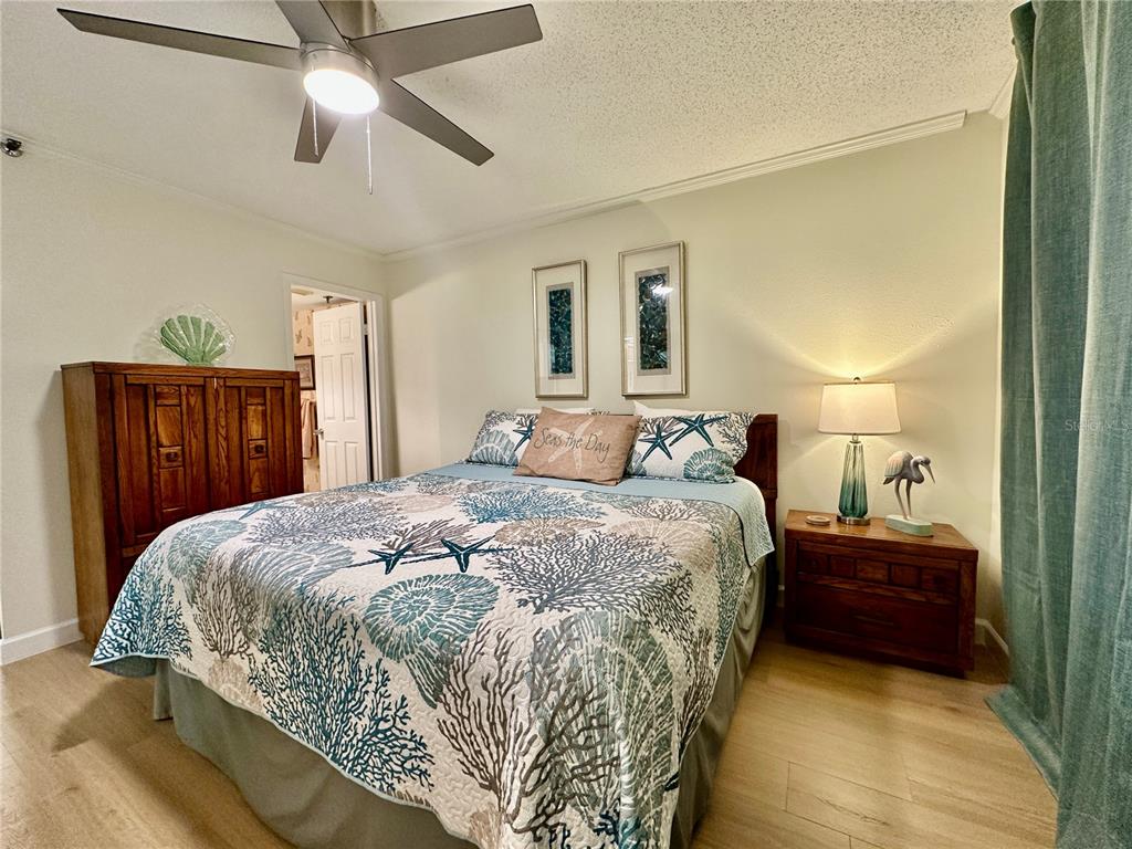 15462 Gulf Boulevard, Unit 501 Madeira Beach, FL 33708 - Photo 68 of 88 a bedroom with a bed and wooden floor