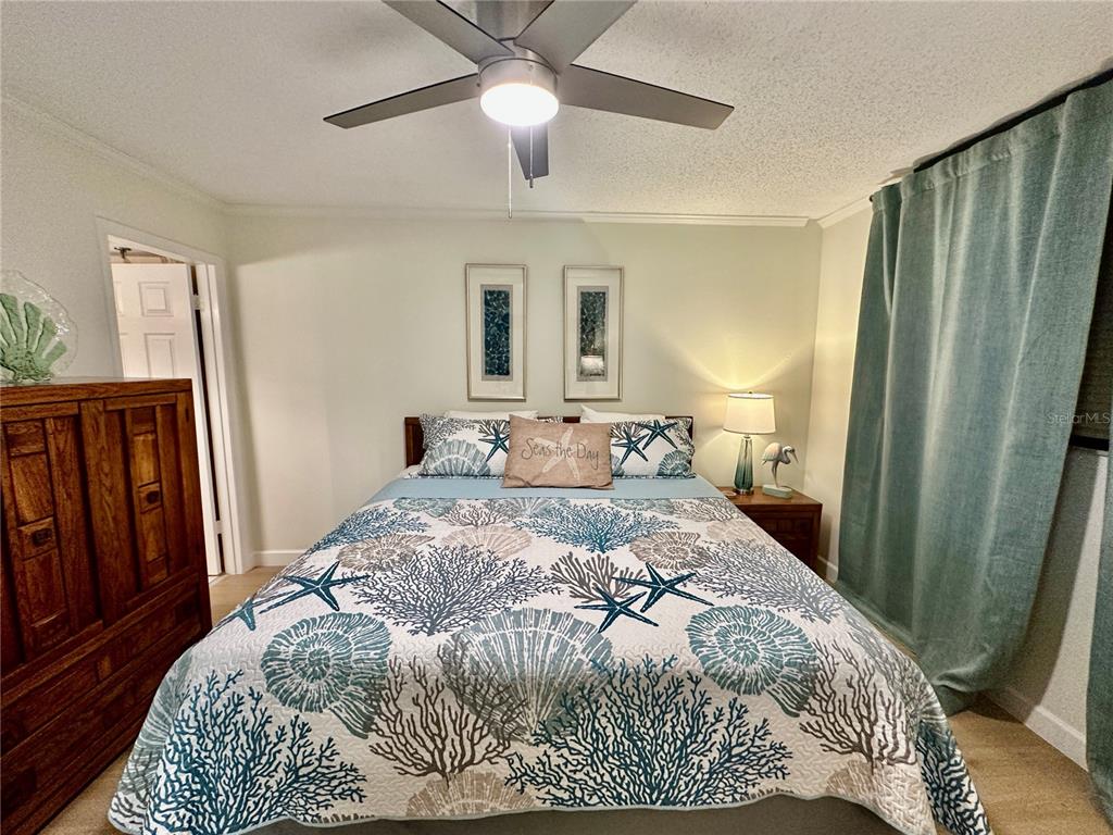 15462 Gulf Boulevard, Unit 501 Madeira Beach, FL 33708 - Photo 71 of 88 a bedroom with a large bed and a chandelier