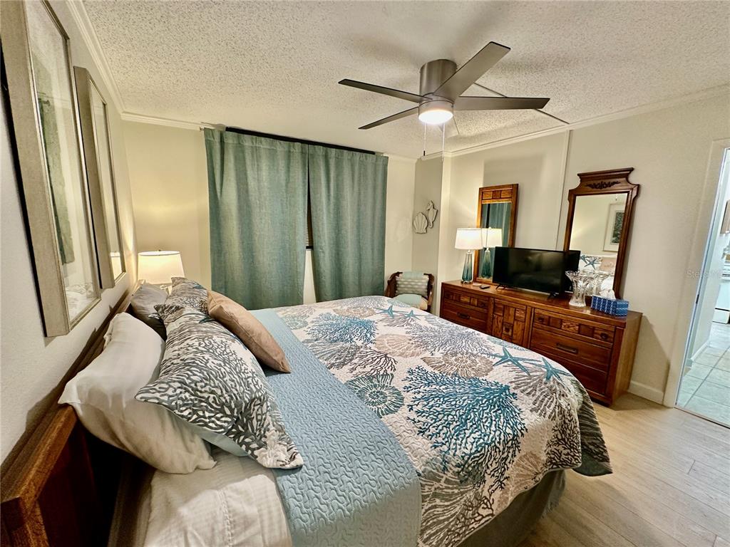 15462 Gulf Boulevard, Unit 501 Madeira Beach, FL 33708 - Photo 74 of 88 a bedroom with a bed a window and a television