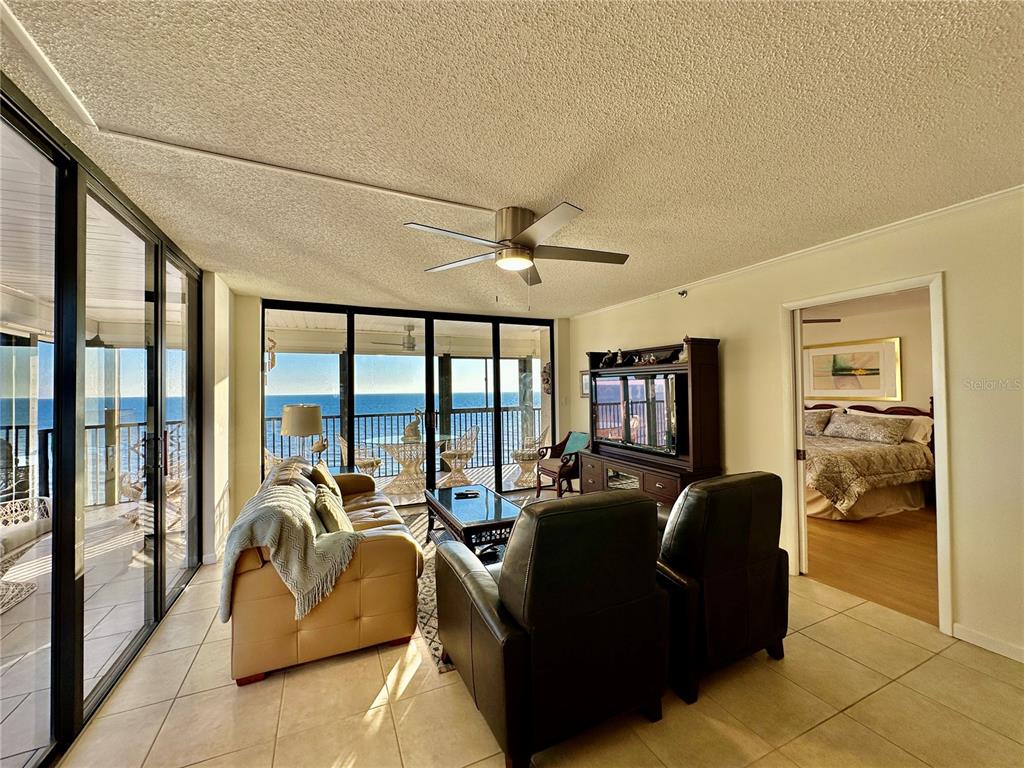 15462 Gulf Boulevard, Unit 501 Madeira Beach, FL 33708 - Photo 83 of 88 a living room with furniture and a floor to ceiling window