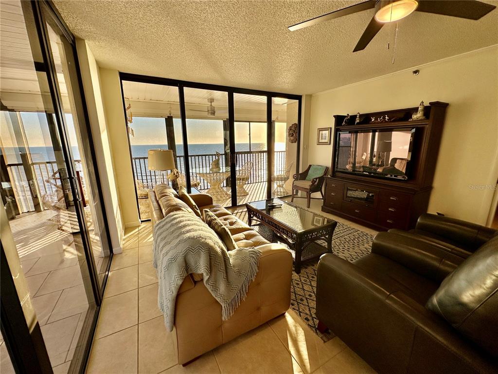 15462 Gulf Boulevard, Unit 501 Madeira Beach, FL 33708 - Photo 86 of 88 a living room with furniture and a floor to ceiling window