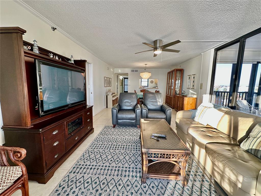 15462 Gulf Boulevard, Unit 501 Madeira Beach, FL 33708 - Photo 87 of 88 a living room with furniture and a flat screen tv
