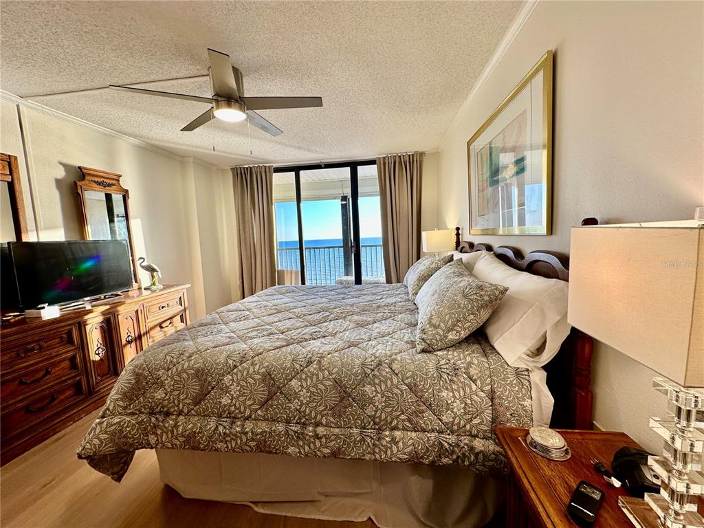 15462 Gulf Boulevard, Unit 501 Madeira Beach, FL 33708 - Photo 9 of 88 a bedroom with a bed and flat screen tv