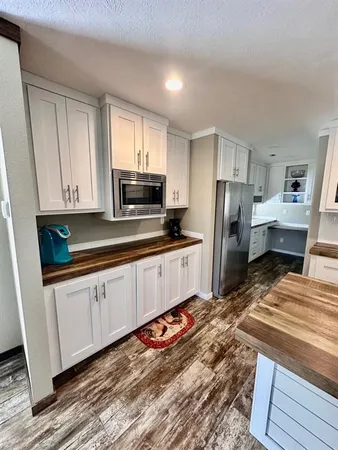 a kitchen with stainless steel appliances a refrigerator sink and microwave