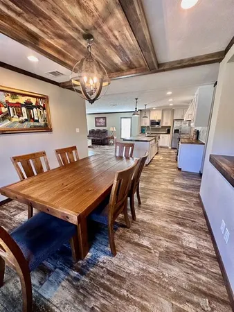 a dining room with a wooden table and chairs