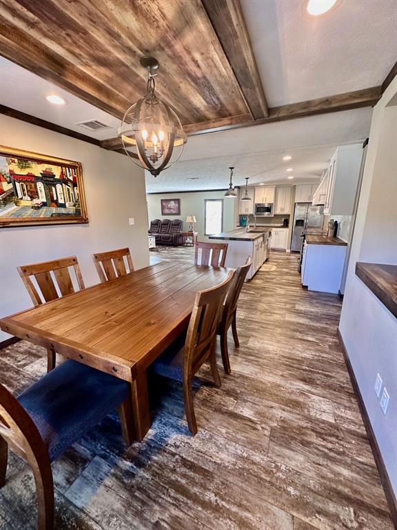 344 JP Cave Road Sherman, TX 75090 - Photo 13 of 21 a dining room with a wooden table and chairs