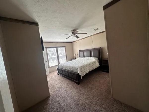 a bedroom with a bed lamp and a window