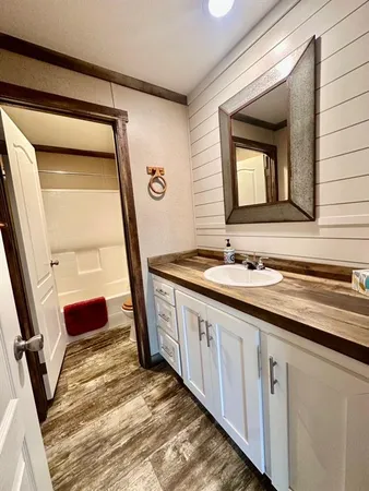 a bathroom with a double vanity sink and a mirror