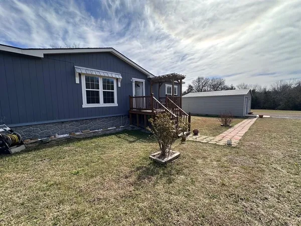 a backyard of a house with table and chairs
