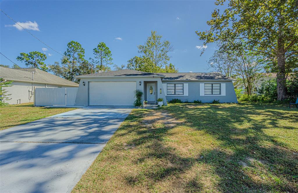 3482 Dow Lane Spring Hill, FL 34609 - Photo 1 of 30 a view of a house with a yard
