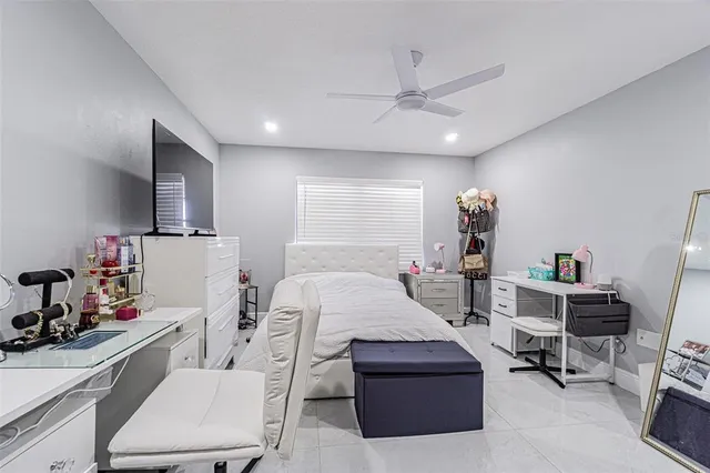 a bedroom with furniture and a flat screen tv