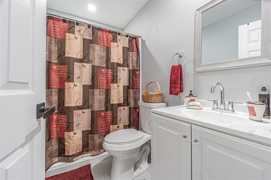 3482 Dow Lane Spring Hill, FL 34609 - Photo 20 of 30 a bathroom with a sink a toilet and shower curtain