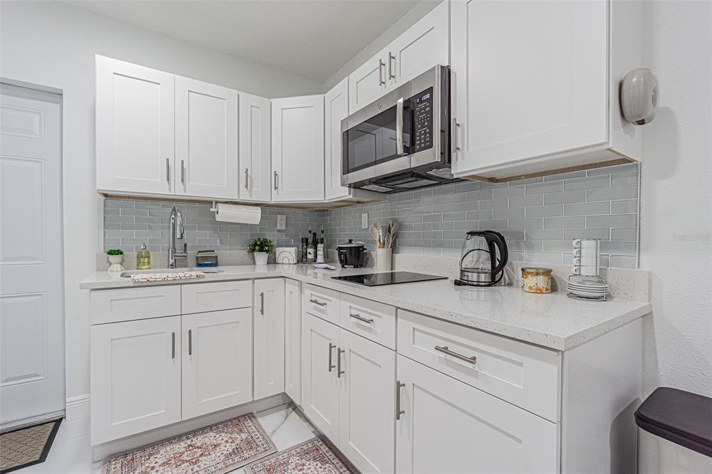 3482 Dow Lane Spring Hill, FL 34609 - Photo 28 of 30 a kitchen with stainless steel appliances granite countertop white cabinets a sink and dishwasher