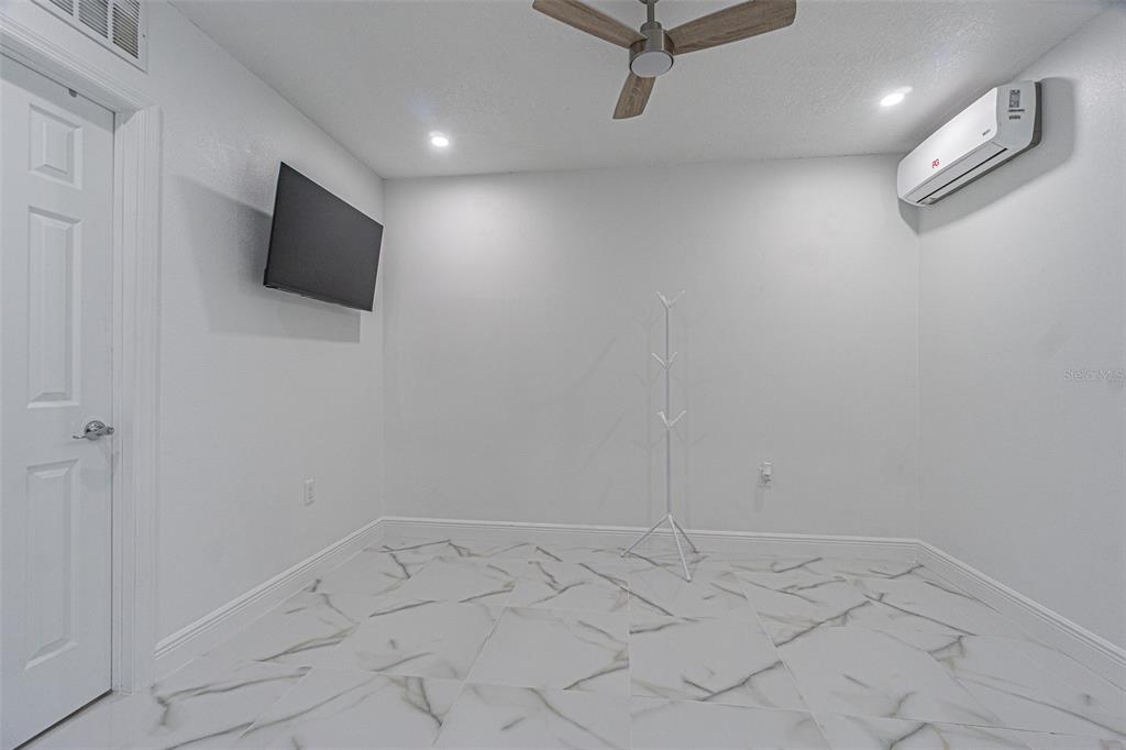 3482 Dow Lane Spring Hill, FL 34609 - Photo 30 of 30 a view of a livingroom with wooden floor and a flat screen tv