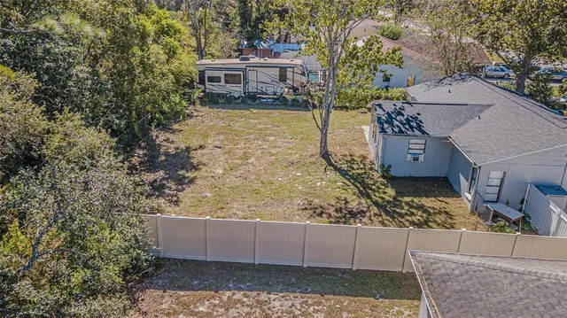 a kitchen with refrigerator and chairs